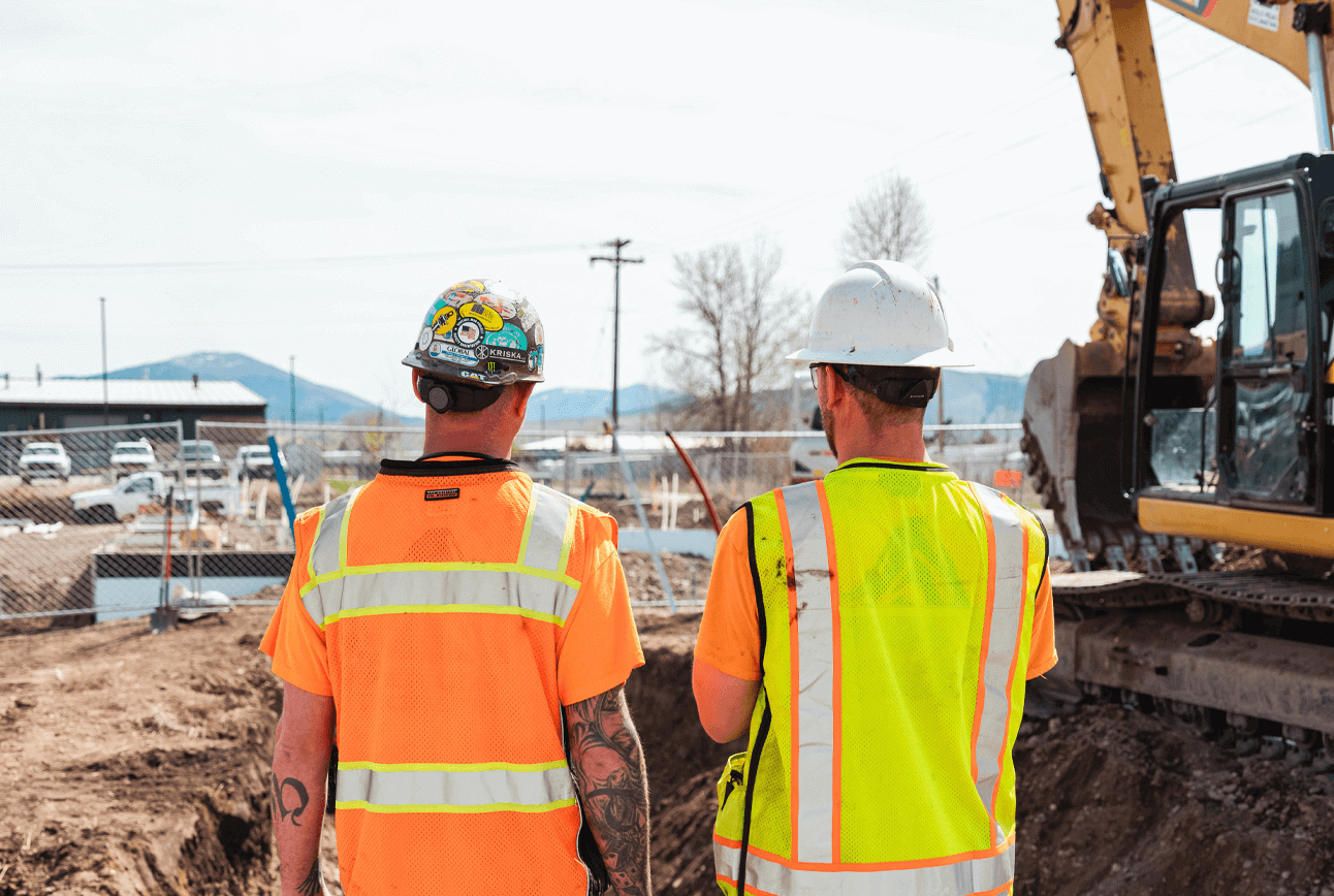 Two workers overseeing a construction