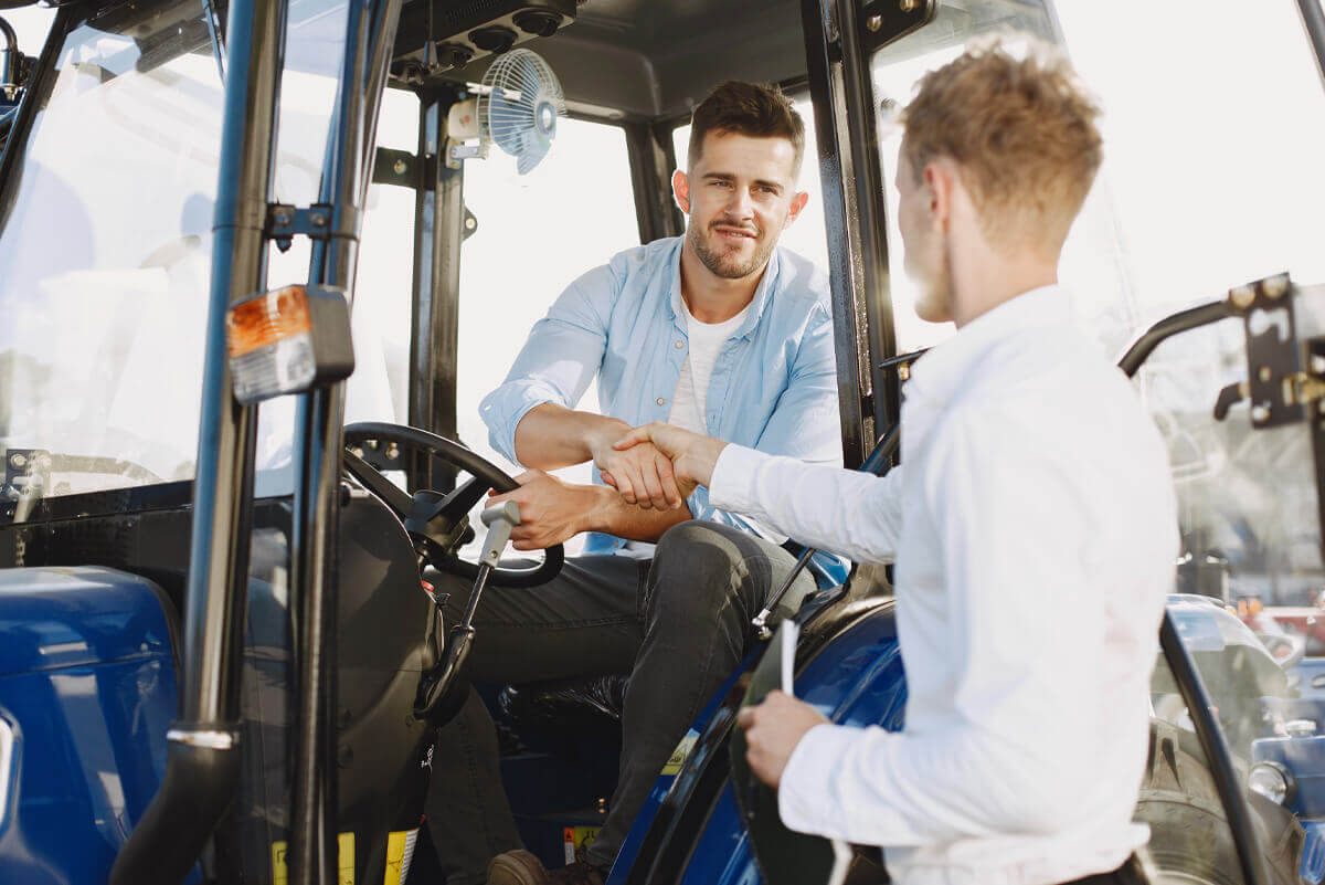 A farmer doing business with a tractor seller