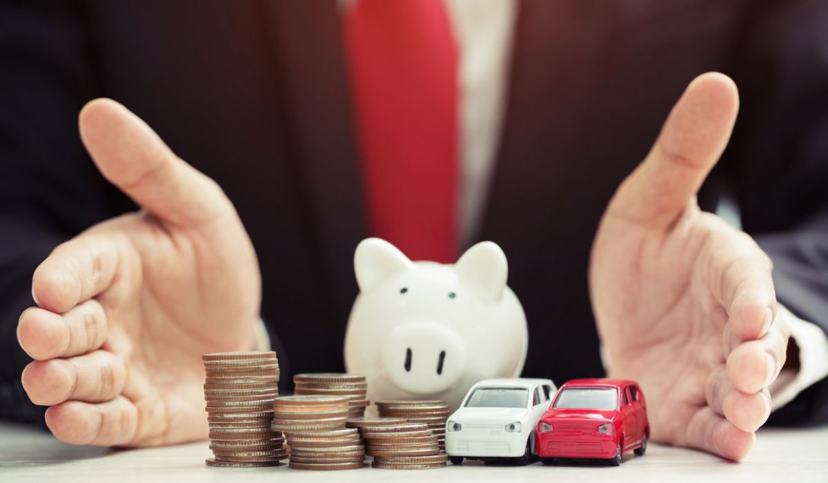 Businessman suit hand holding conins, piggyback and model toy car.
