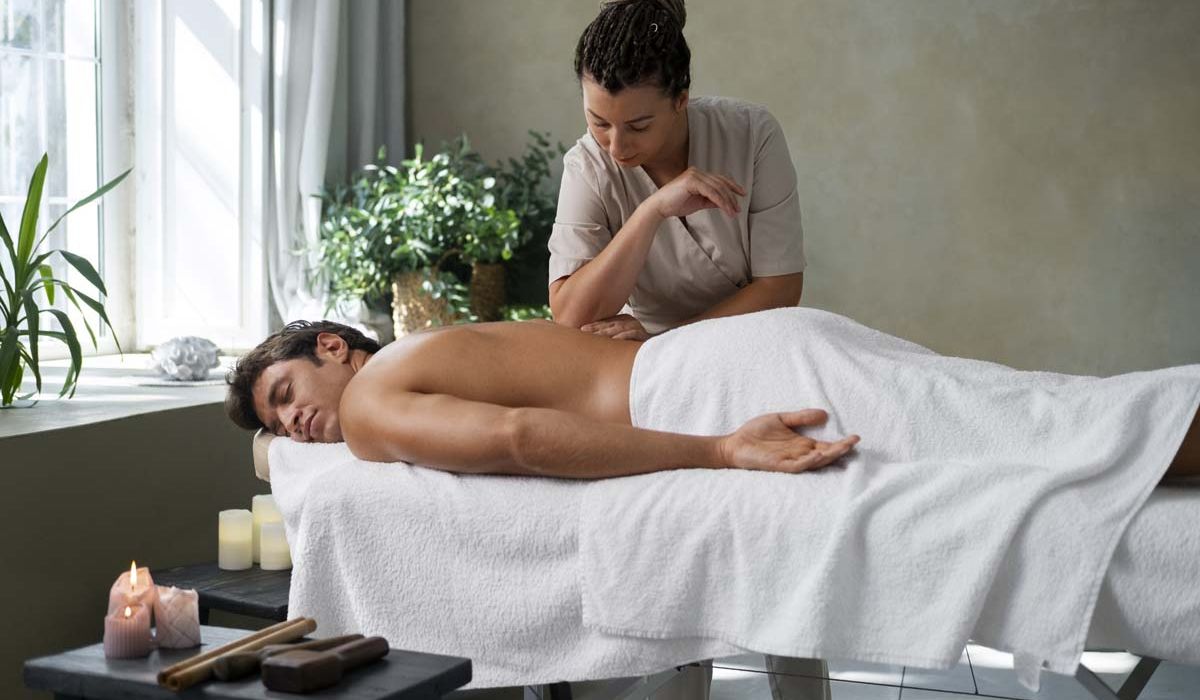 A man receiving a relaxing massage in a serene spa environment.