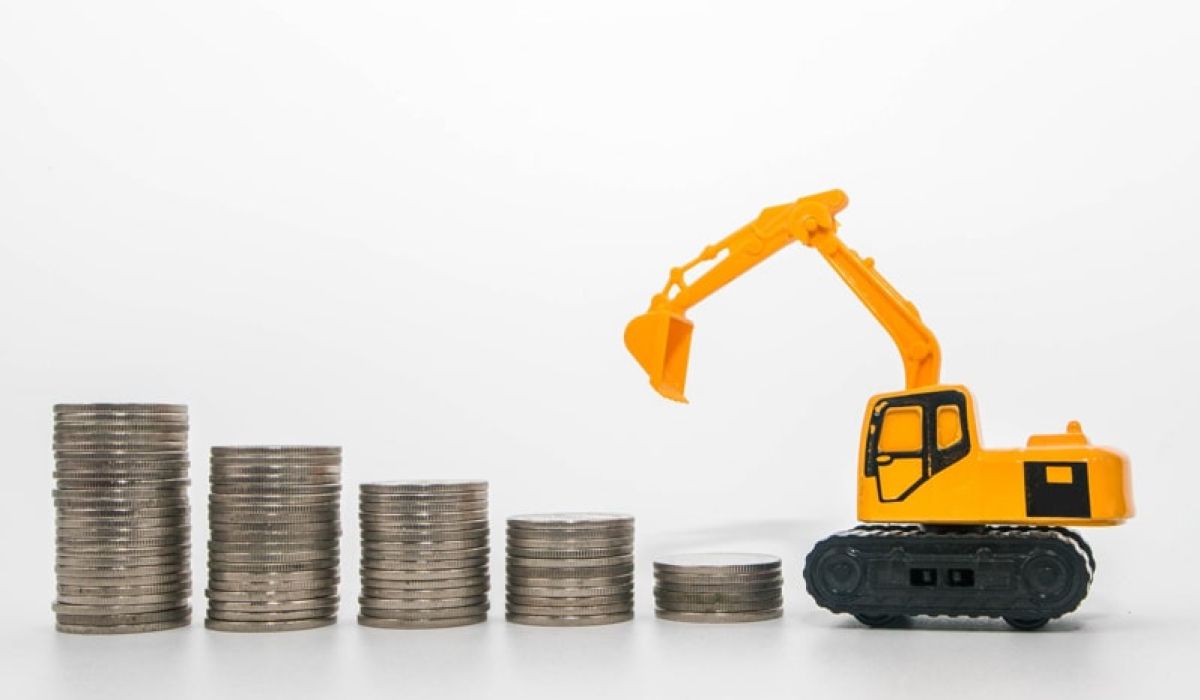 Forklift toy next to coins