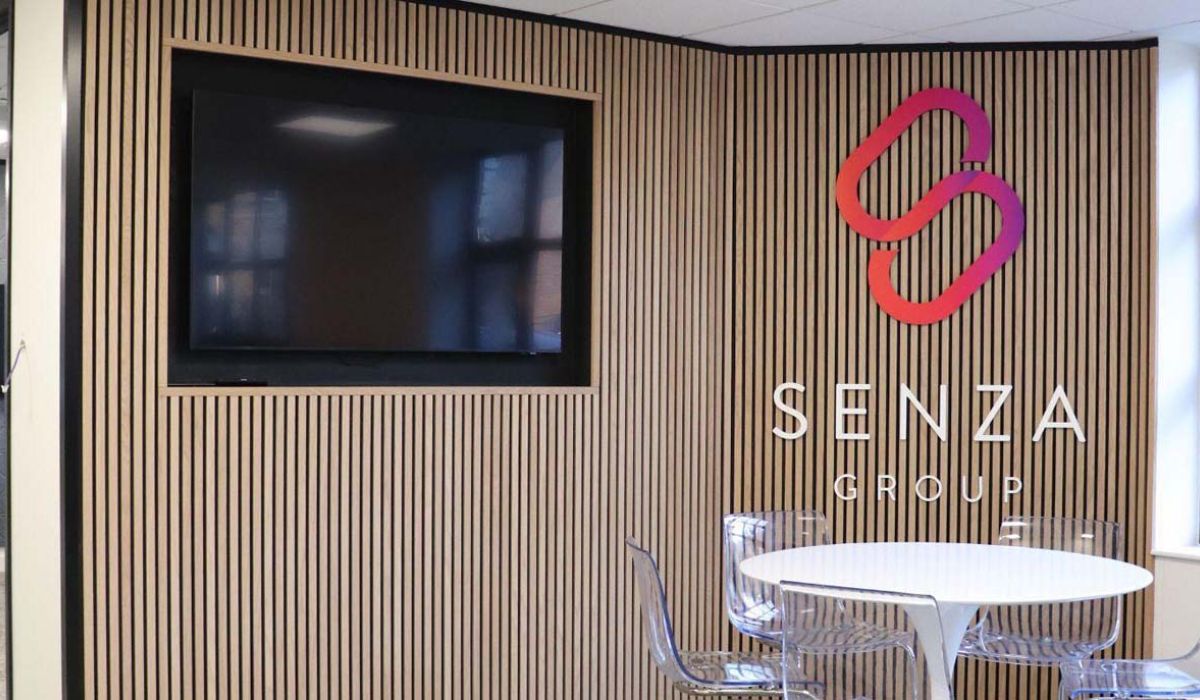 A conference room featuring a large TV and several chairs arranged for meetings.