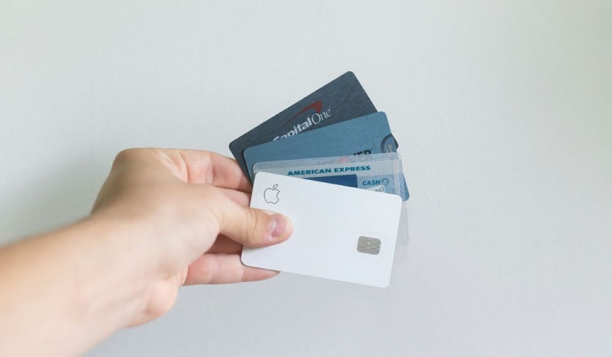 Person holding up credit cards