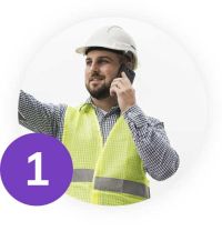 Construction worker talking through a mobile phone 