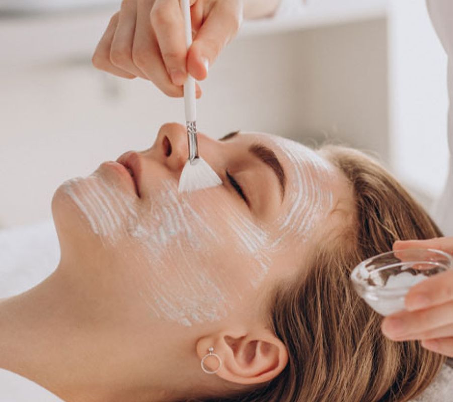 A woman receiving a facial treatment