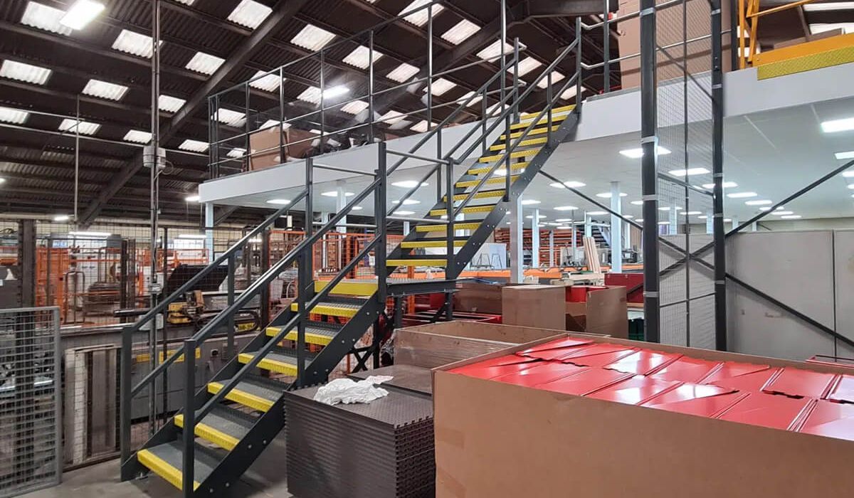A warehouse interior featuring stairs and stacked boxes, illustrating a busy storage environment.