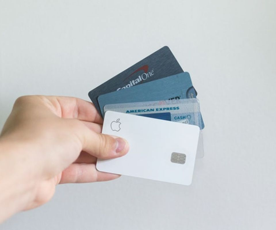 Person holding up credit cards