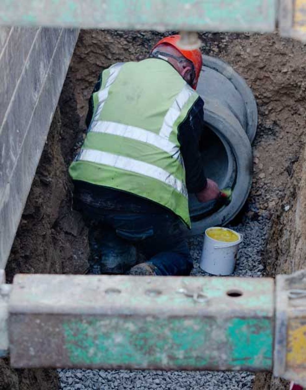 Man working on a drainage pipe